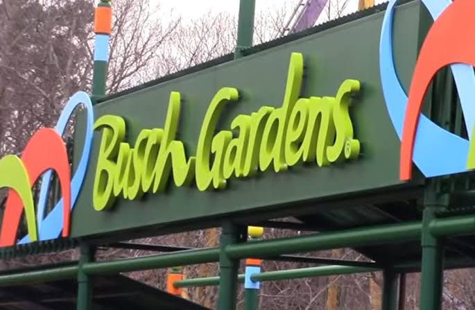 A sign for Busch Gardens Williamsburg entrance during a sunny afternoon.