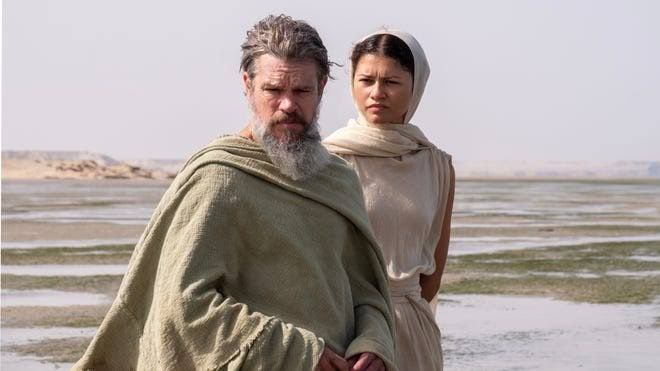 Queen Penelope and her handmaiden Melantho stand together in a scene from the film The Odyssey.