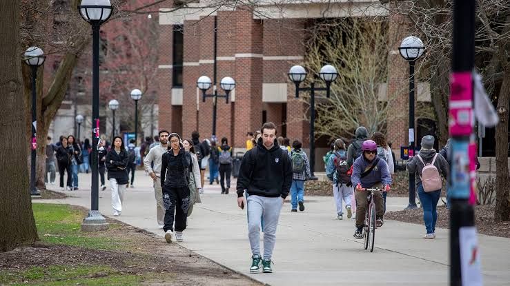 University of Michigan students walking across the campus in Ann Arbor during the spring semester.