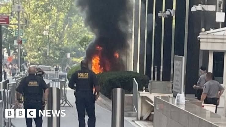 Fire burning on the stairs outside the 26 Federal Plaza federal building in New York City.