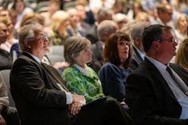 A senior missionary couple looks at a large painting of Jesus Christ at the 196th Annual General Conference.