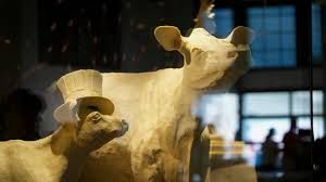 A butter sculpture of a cow and calf wearing an Uncle Sam hat inside the Ohio State Fair Dairy Products Building.