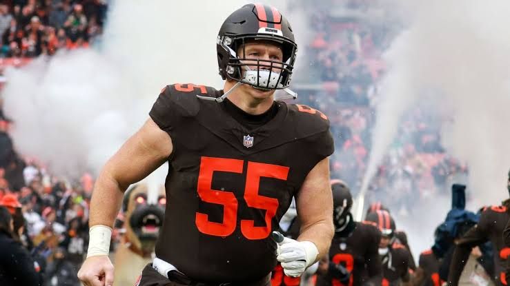 Ethan Pocic standing on the field in his uniform during an NFL game.