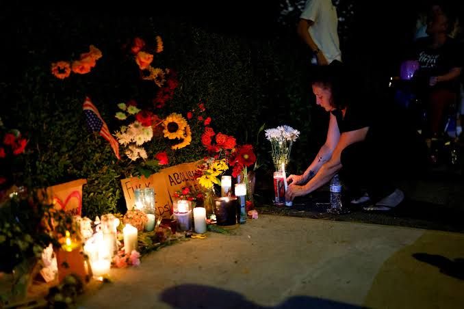A public memorial with flowers and candles for Johan Sebastian Duran Guerrero in Biddeford, Maine.