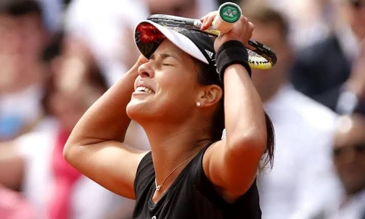 Ana Ivanovic playing a forehand shot during a professional tennis match on clay at Roland Garros.