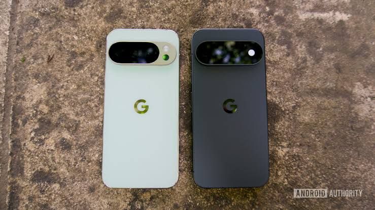 A black Pixel 11 Pro sits on a table next to a jade colored phone showing the contrast in finish.