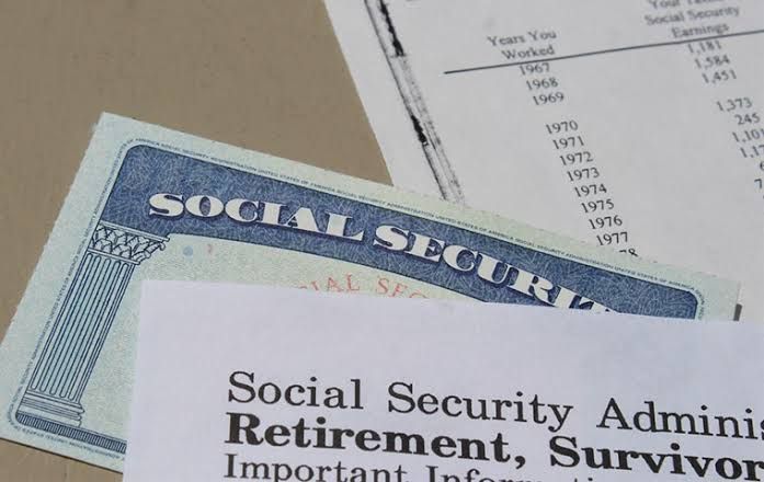 Social Security trust fund documents on a wooden table highlighting the 2034 exhaustion timeline.