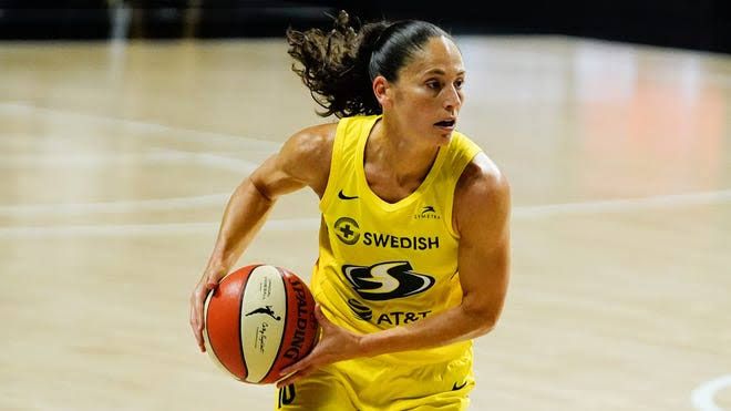 Sue Bird dribbling the basketball while playing for the Seattle Storm during a WNBA game.