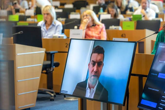 Donny Greenberg speaking via video link at a European Parliament session in Brussels.