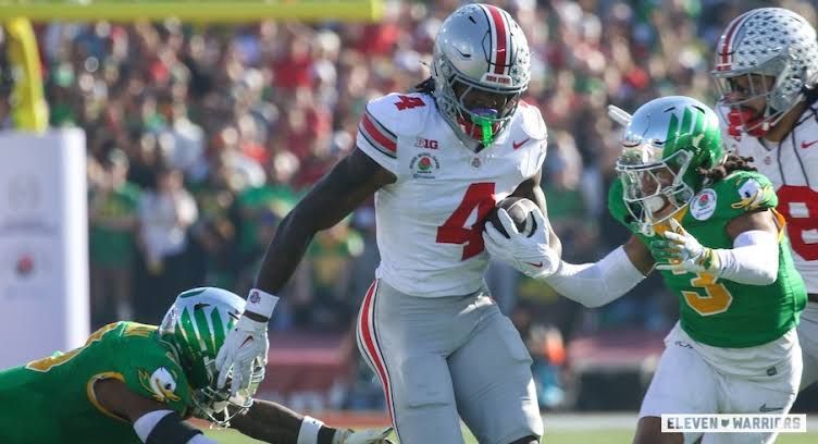 Ohio State wide receiver Jeremiah Smith running with the football during a game.