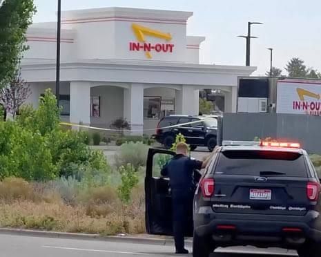 An emergency responder stands near an In-N-Out Burger restaurant in Twin Falls, Idaho following a fatal shooting.