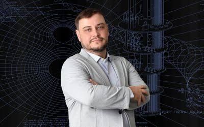 Americo Cunha standing in front of an illustrated digital background featuring quantum computing network nodes.