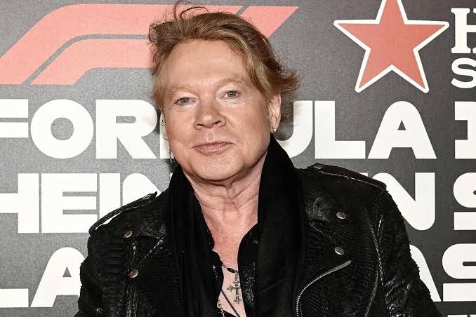 Axl Rose performing on stage at a concert in 2024.