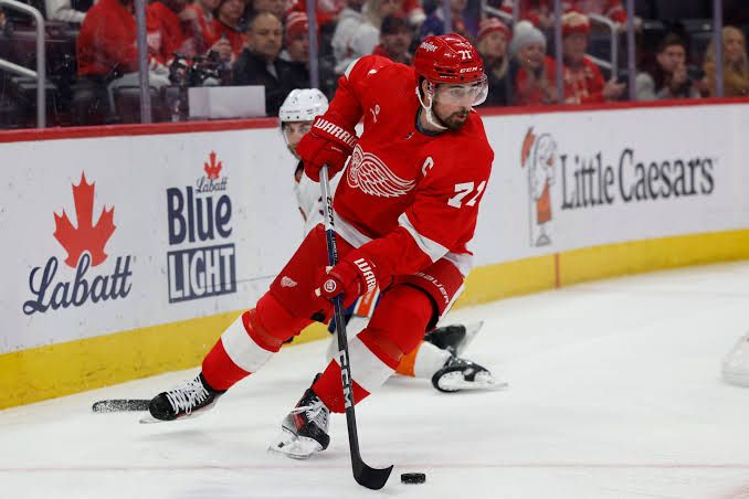 Dylan Larkin skating on the ice during a Detroit Red Wings game.