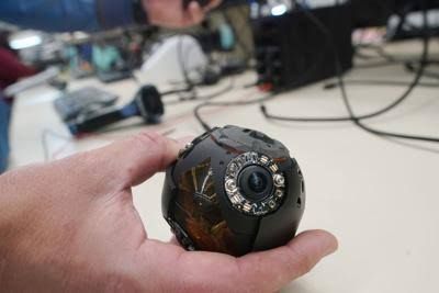 Jim Milks demonstrates a Bounce Imaging 360-degree tactical camera on a pole at the company's manufacturing facility.