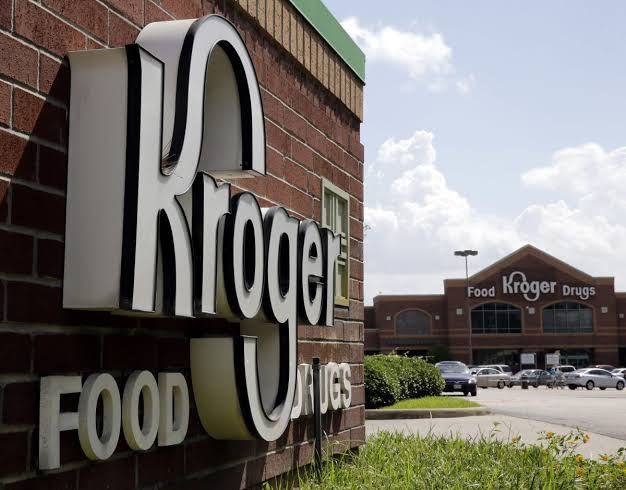 Kroger pharmacy signage above a prescription counter in a grocery store.
