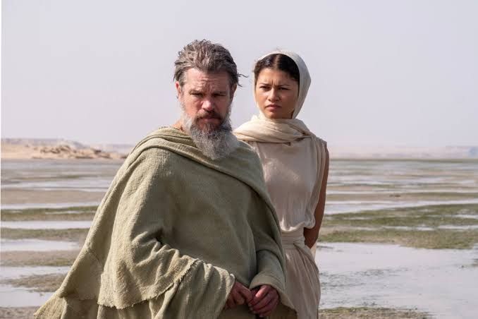 Matt Damon as Odysseus and Zendaya as Athena stand together in a scene from Christopher Nolan's The Odyssey.