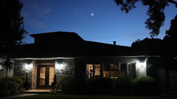 A modern single-family house exterior at twilight, illustrating the financial commitment of homeownership.