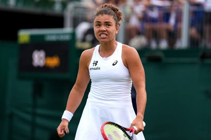 Jasmine Paolini waving to the crowd after a match at Wimbledon in 2026.