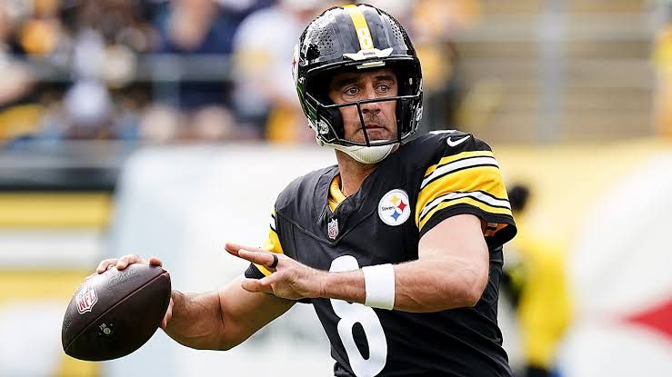 Pittsburgh Steelers quarterback Aaron Rodgers listens to head coach Mike McCarthy during practice.