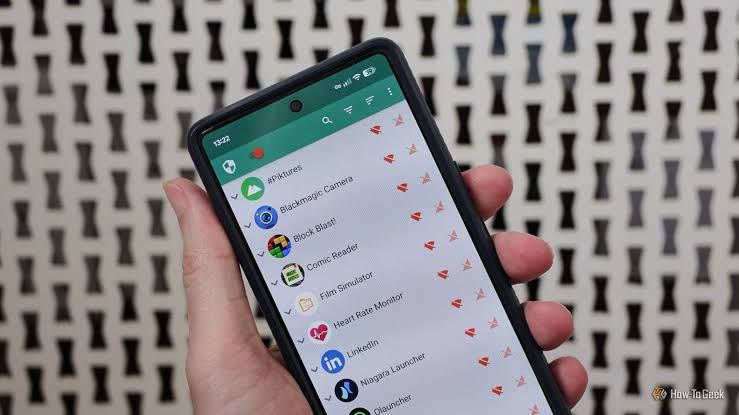 A smartphone screen showing the NetGuard interface with toggles to block Wi-Fi and mobile data for various apps.