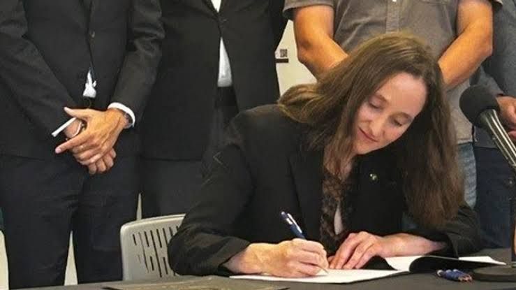 Mayor Katie Wilson signs an executive order at a press conference to establish a new city economic task force.