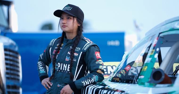 Mia Lovell stands next to her race car at Sonoma Raceway during the ARCA Menards Series West.