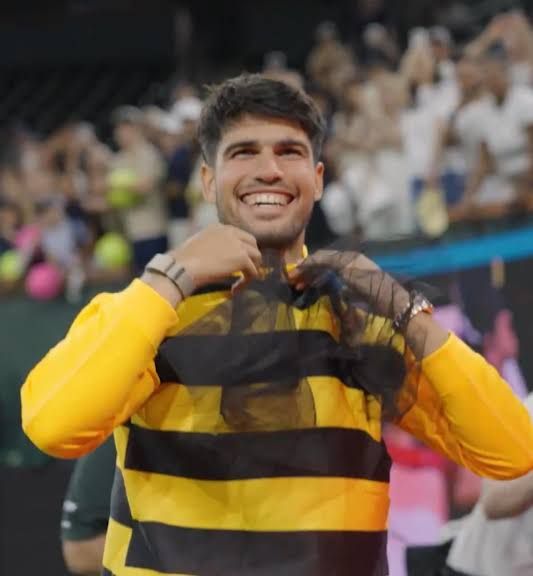 Carlos Alcaraz during a high-intensity tennis match focusing on his movement and court coverage.