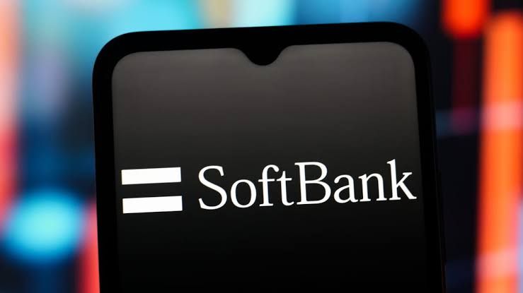 Smartphone displaying the SoftBank Group logo against a dark background in a business news context.
