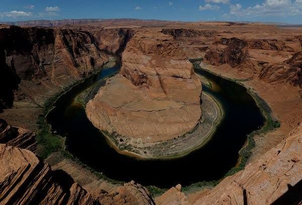 Aerial view of low water levels at Lake Mead reservoir revealing the bathtub ring line on the canyon walls.