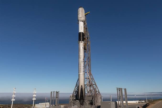 A Falcon 9 rocket standing vertically on the launch pad at Vandenberg Space Force Base.