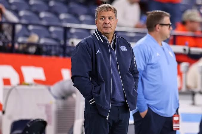 Mike Lombardi standing on the sideline during a UNC football game in Chapel Hill.