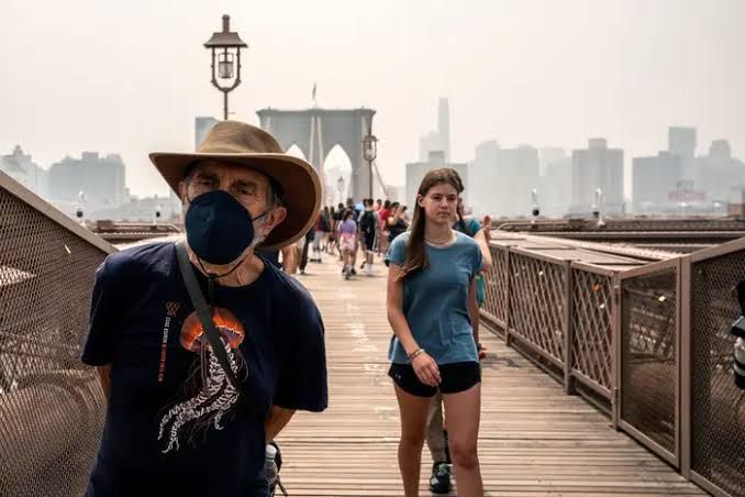 A hazy skyline in New York City with buildings obscured by smoke from Canadian wildfires.