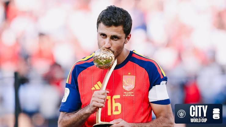 Manchester City midfielder Rodri lifting the FIFA World Cup trophy after Spain won the 2026 tournament.
