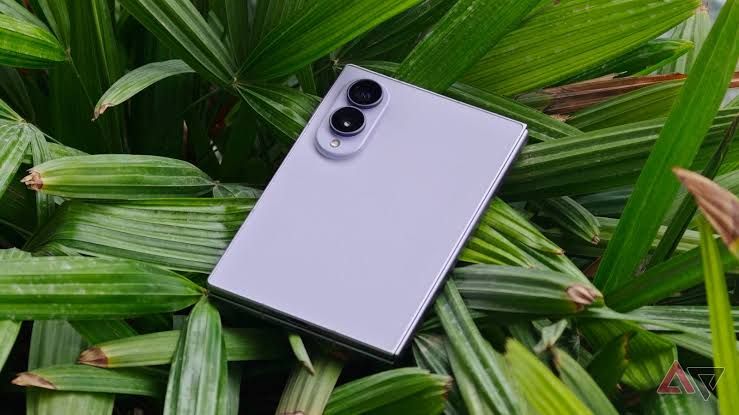 An unfolded Samsung Galaxy Z Fold 8 displayed on a table next to internal settings menu options for device repair.