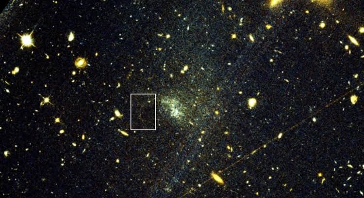 A technical image showing a distant ultra-diffuse galaxy with faint stellar streams captured by telescope equipment.