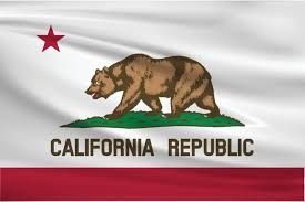 California state flag flying in front of a government building, representing the legal jurisdiction for employment disputes.