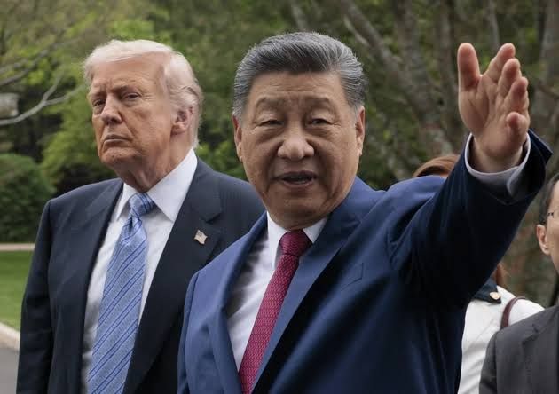 President Donald Trump and Chinese President Xi Jinping walk together during a state visit in Beijing.