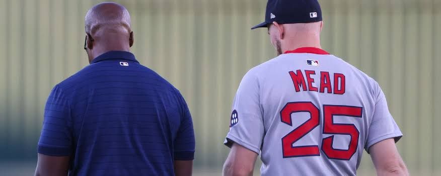 Curtis Mead of the Boston Red Sox walking off the field after being hit on the left wrist during his team debut.