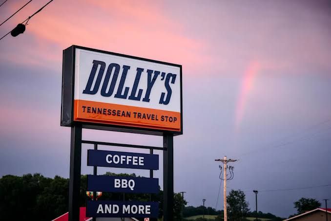 A colorful mural of Dolly Parton with butterfly wings painted on the exterior wall of the Tennessean Travel Stop.