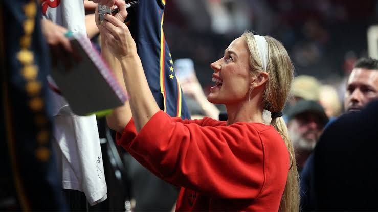 Indiana Fever forward Sophie Cunningham signing autographs for a fan after a WNBA game against the Portland Fire.