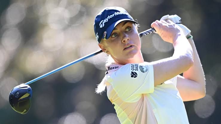 Charley Hull prepares for a golf shot at the AIG Women's Open tournament.