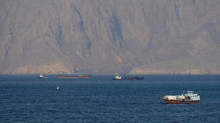 Oil tanker vessel navigating through the Strait of Hormuz during a period of heightened geopolitical tension.