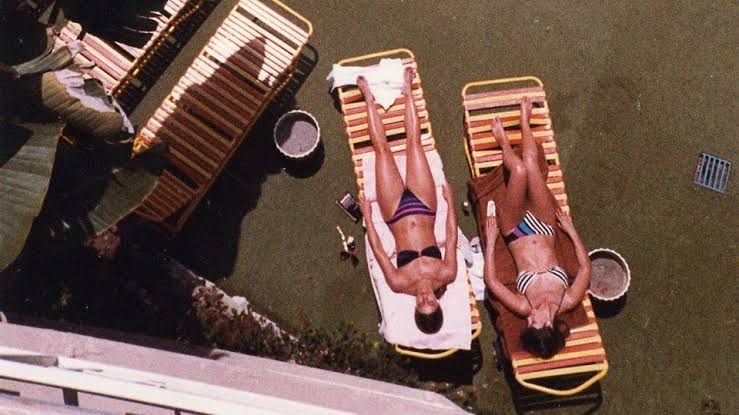 Plastic lounge chairs at a pool in 1984, reflecting the aesthetic of Bret Easton Ellis's novel The Shards.