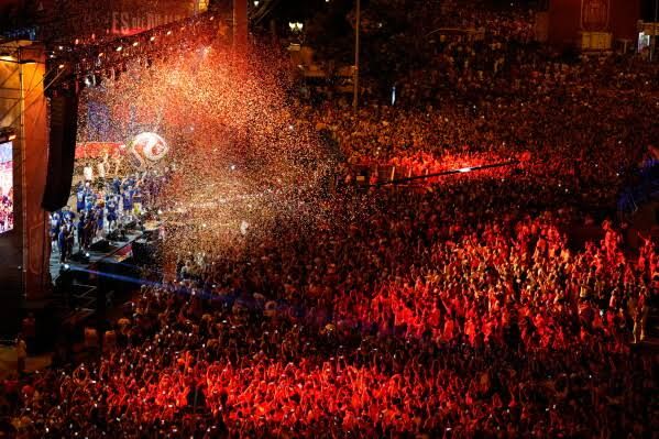 Spain's national soccer team players celebrating atop a bus during the victory parade in Madrid on July 20, 2026.