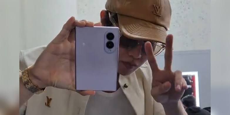 Samsung Galaxy Z Fold 8 in purple held in a hand showing the wide exterior display.