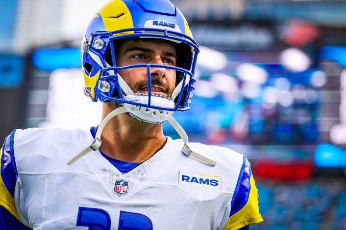Jimmy Garoppolo standing on an NFL field in uniform during a game.