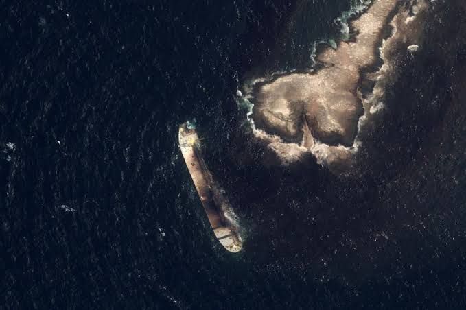 The damaged tanker Caroline Bezengi sits low in the water off the coast of Oman following an incident.