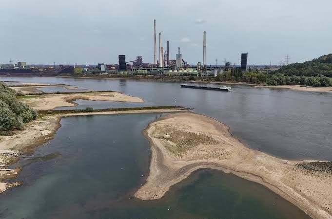 Cargo vessel sitting near exposed riverbed on the Rhine River in Duisburg, Germany during the August 2026 heat wave.