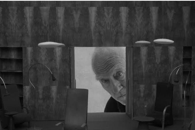 Director Wim Wenders standing near a model of the David Geffen Galleries during a film promotional event.